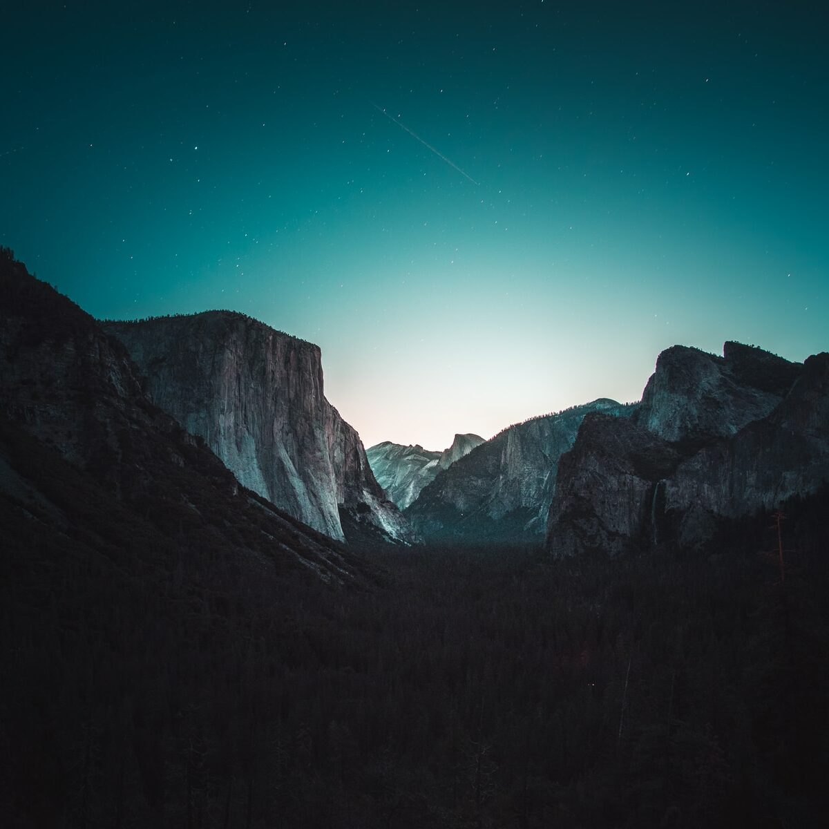 gray and black mountain under starry sky